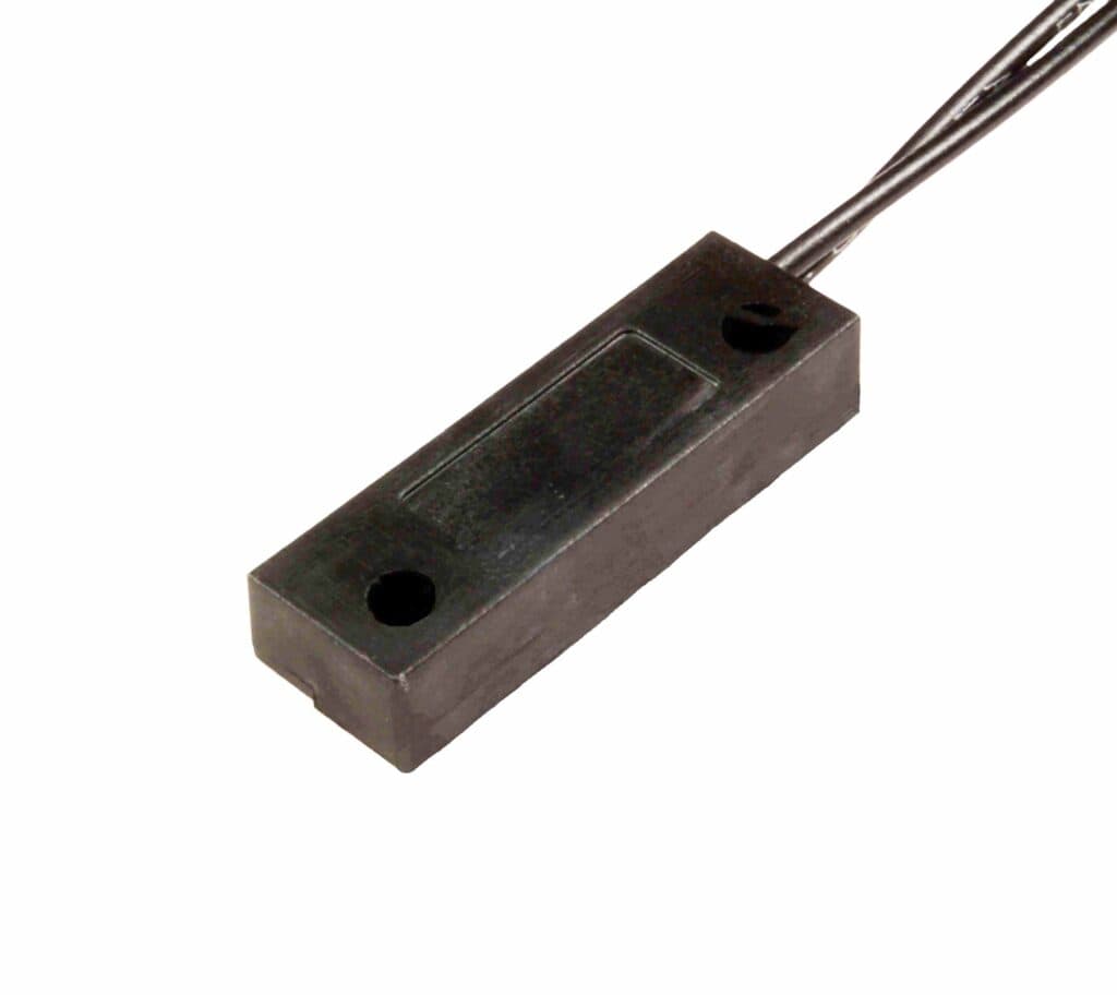 Black rectangular magnetic reed switch sensor housing with two mounting holes and a wire lead