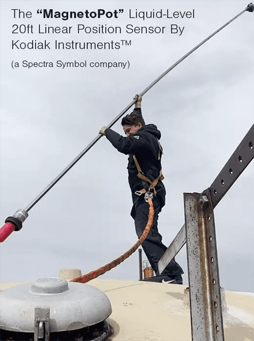 Technician in a safety harness on top of a storage tank installing a 20 ft MagnetoPot liquid-level linear position sensor by Kodiak Instruments, a Spectra Symbol company.