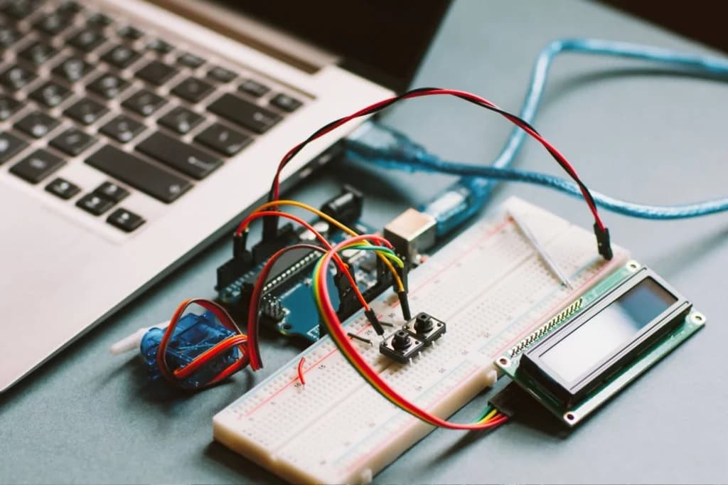 An Arduino prototype connected to a laptop and breadboard, representing a smart build that uses thin potentiometers (SoftPot) for compact, flexible, and smooth analog control.