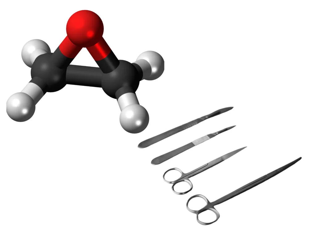 3D ball-and-stick model of an ethylene oxide molecule beside stainless steel scalpels and surgical scissors.