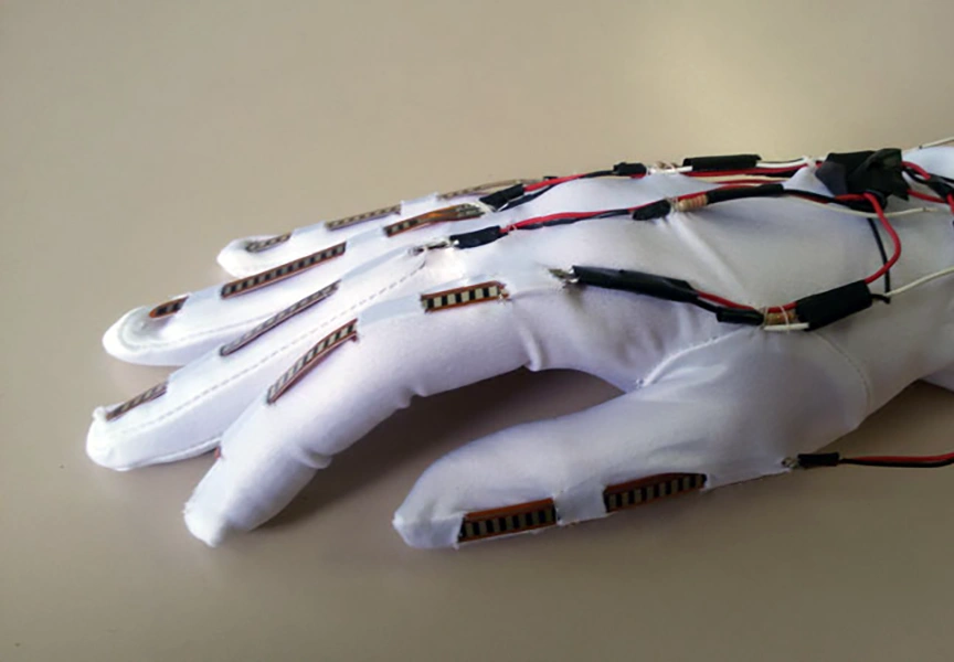 Photo of Specta Symbol Flex Sensors sewn into a glove for bio-feedback when hand moves